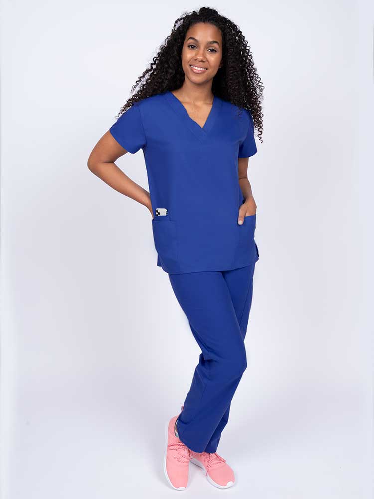 Woman wearing a Luv Scrubs by MedWorks Women's V-neck Scrub Top in royal with 2 front patch pockets.