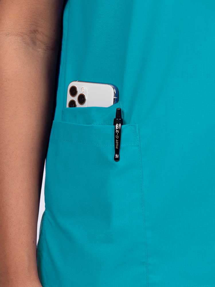 A close look at the right side pocket on the Luv Scrubs by MedWorks Women's V-neck Scrub Top in Turquoise featuring an interior cell phone pocket.