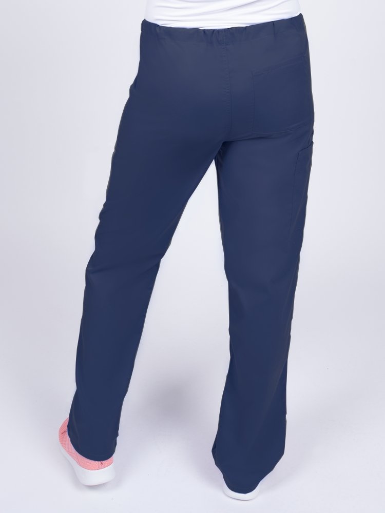 Young female nurse wearing a Luv Scrubs Unisex Drawstring Cargo Pant in navy with 1 back pocket.