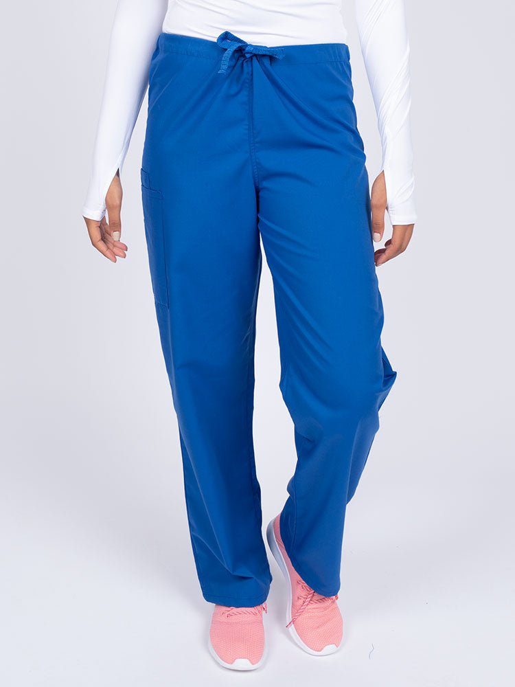 Young nurse wearing a Luv Scrubs Unisex Drawstring Cargo Pant in royal with a total of 3 pockets.