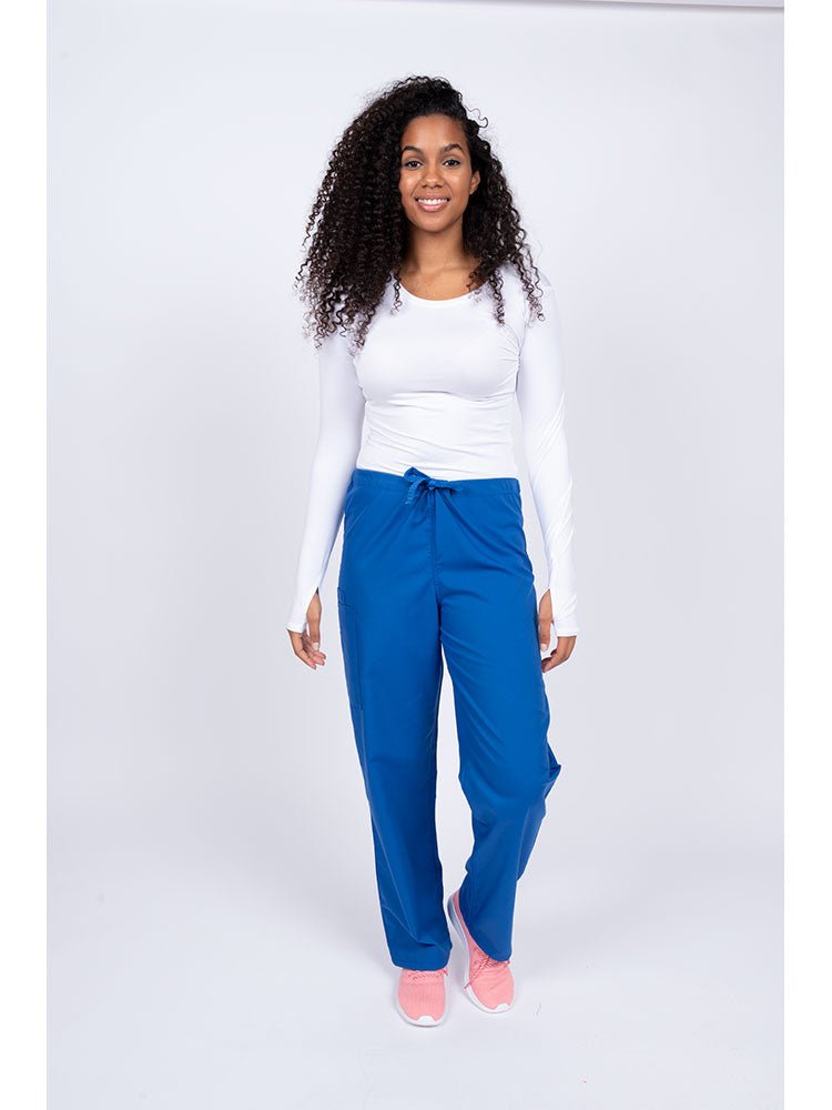 Young nurse wearing a Luv Scrubs Unisex Drawstring Cargo Pant in royal with drawstring waist.
