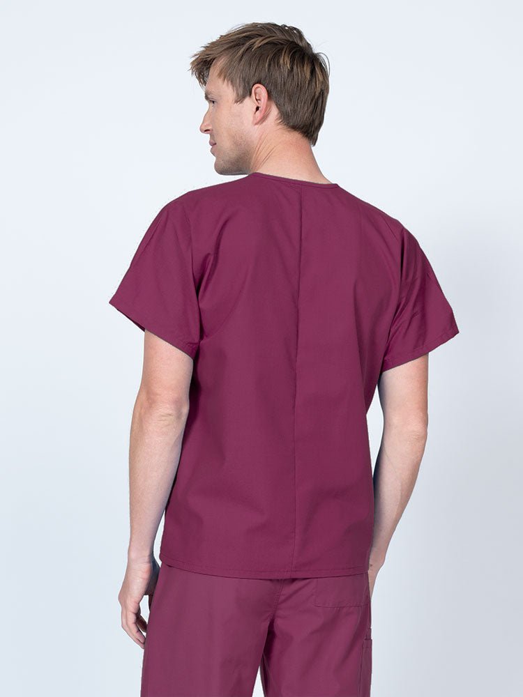 Male nurse wearing a Luv Scrubs Unisex Single Pocket V-Neck Scrub Top in wine with a lightweight, breathable fabric made of 55% Cotton and 45% Polyester.