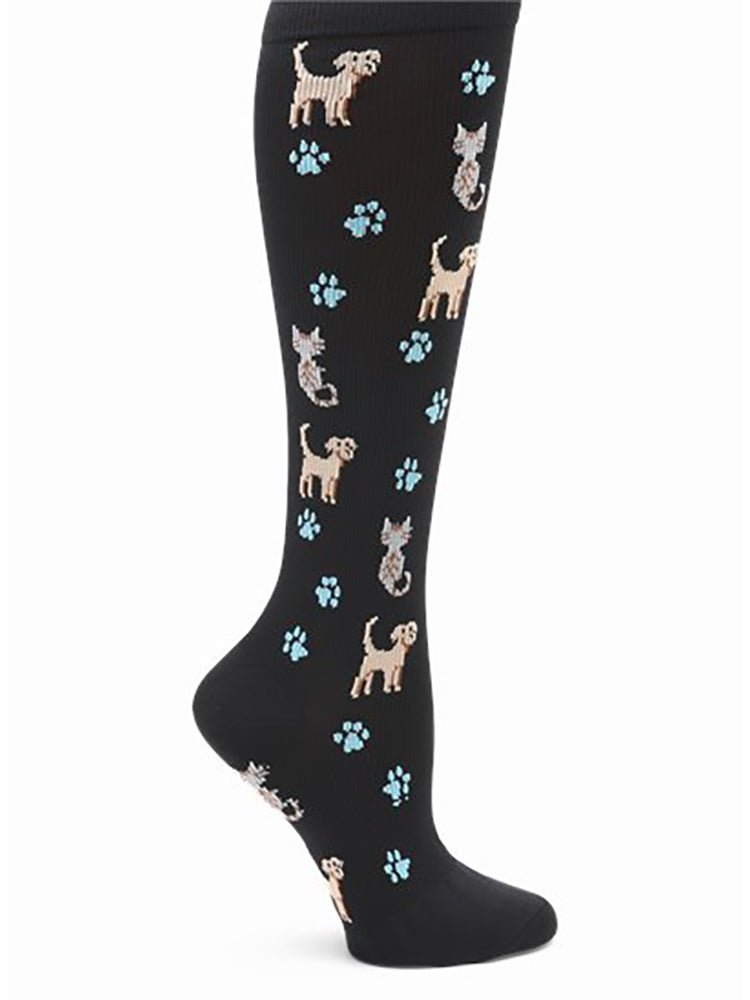 The NurseMates Women's Wide Calf Compression Socks in "Pets N Paws" featuring cute dogs and cats on a black background with blue paw prints scattered throughout.