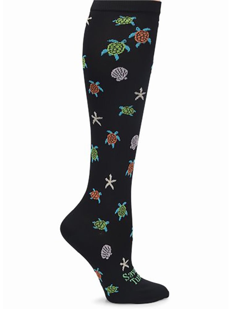 The NurseMates Women's Wide Calf Compression Socks in "Turtles" featuring cute print with multi-colored sea turtles, seashells and starfish on a black background.