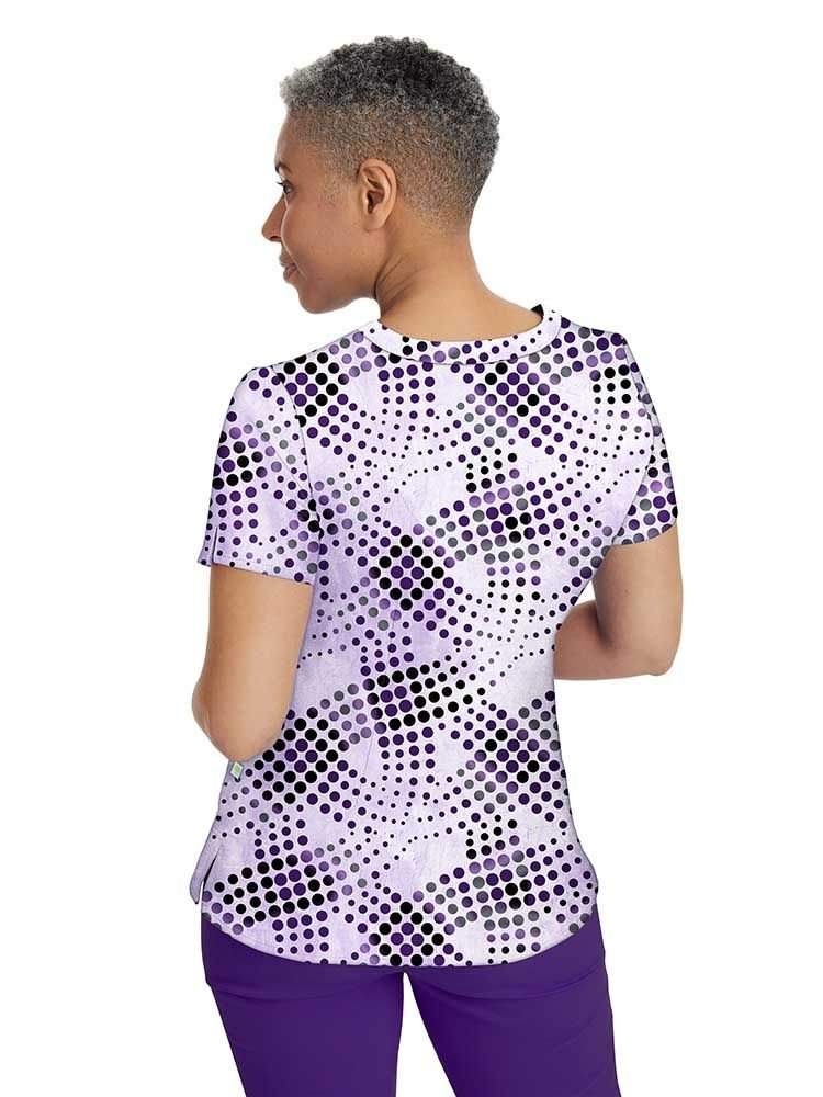 A young female Psychiatric Nurse wearing a Premiere by Healing Hands Women's Amanda Print Top featuring a center back length of 26.5".
