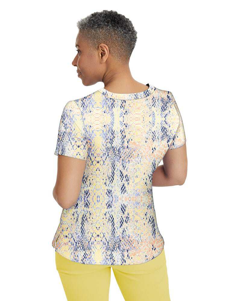 Young female Pediatric Nurse wearing a Premiere by Healing Hands Women's Amanda Print Top in "Summer Skin" featuring darts at the bust & back shaping darts for a flattering fit.