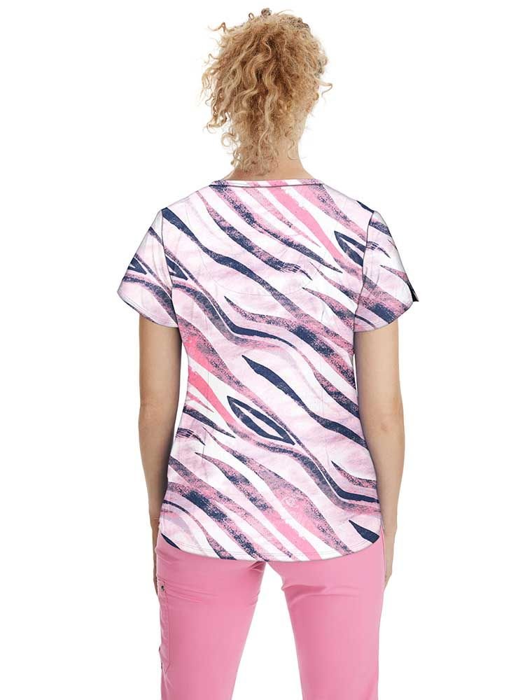 A young female Psychiatric Nurse wearing Women's Isabel Printed Scrub Top in "Wild Stripes" featuring a center back length of 26.5".