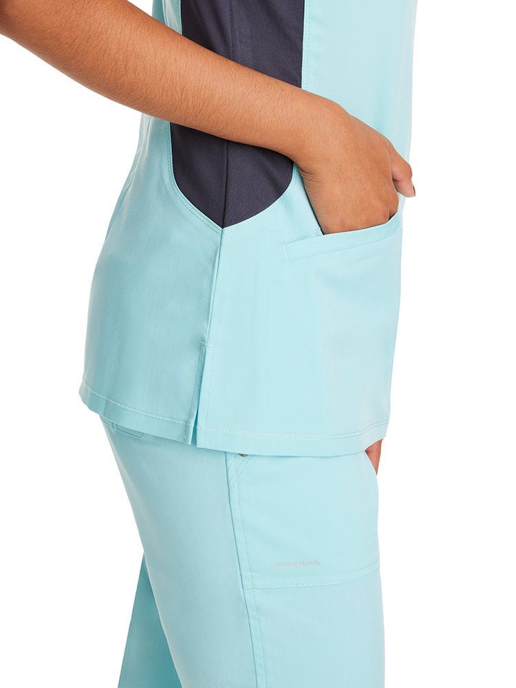 Young female nurse wearing a Purple Label Women's Jessi Y-Neck Scrub Top in "Seabrook" featuring 2 front patch pockets.