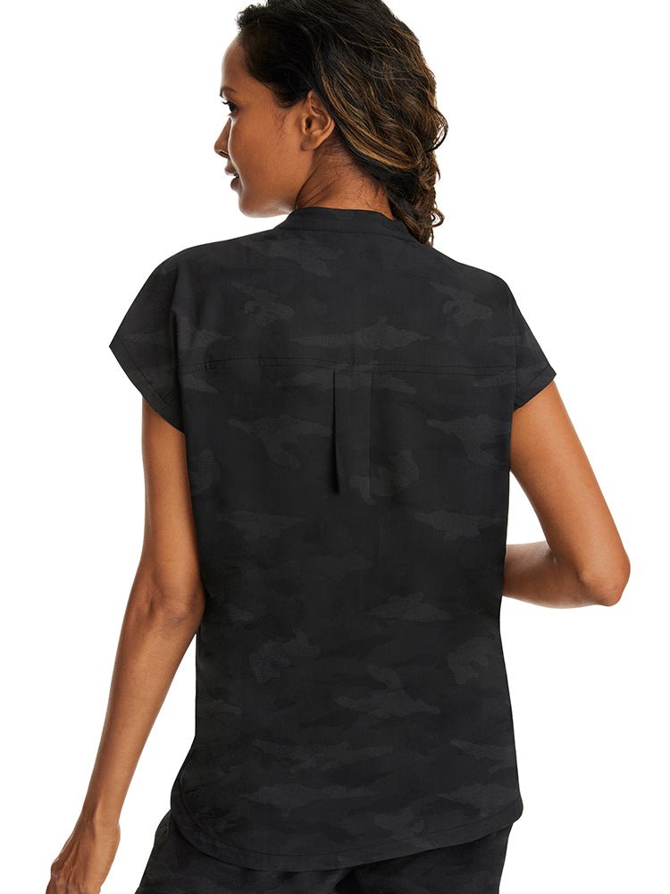 A young female Occupational Therapy Aide wearing a Purple Label Women's Journey Camo Top in Black size Large featuring a center back length of 26.5".