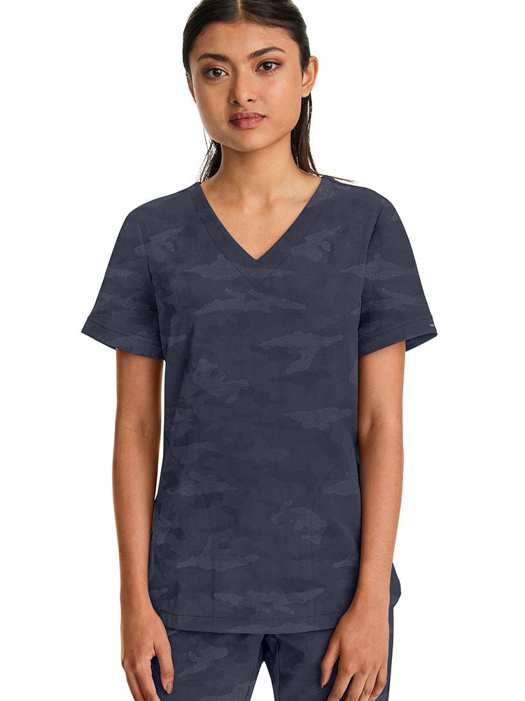 Young woman wearing a Purple Label Women's Joy Camo Top in Pewter featuring a v-neckline.