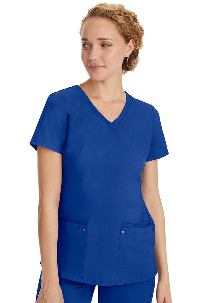 A lady nurse wearing a Purple Label Women's Juliet Yoga Scrub Top in Galaxy Blue featuring a super comfortable stretch fabric made of 77% polyester/20% rayon/3% spandex.