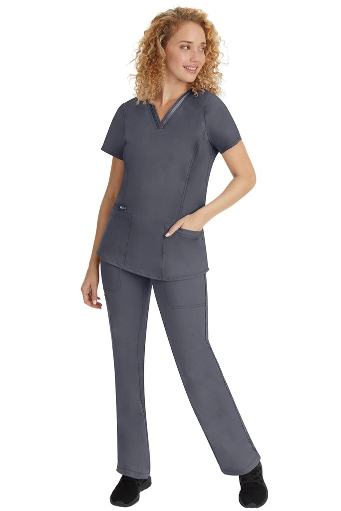 A young lady nurse wearing a Purple Label Women's Jasmin Fashion V-Neck Scrub Top in Pewter with a missy relaxed fit & short sleeves.