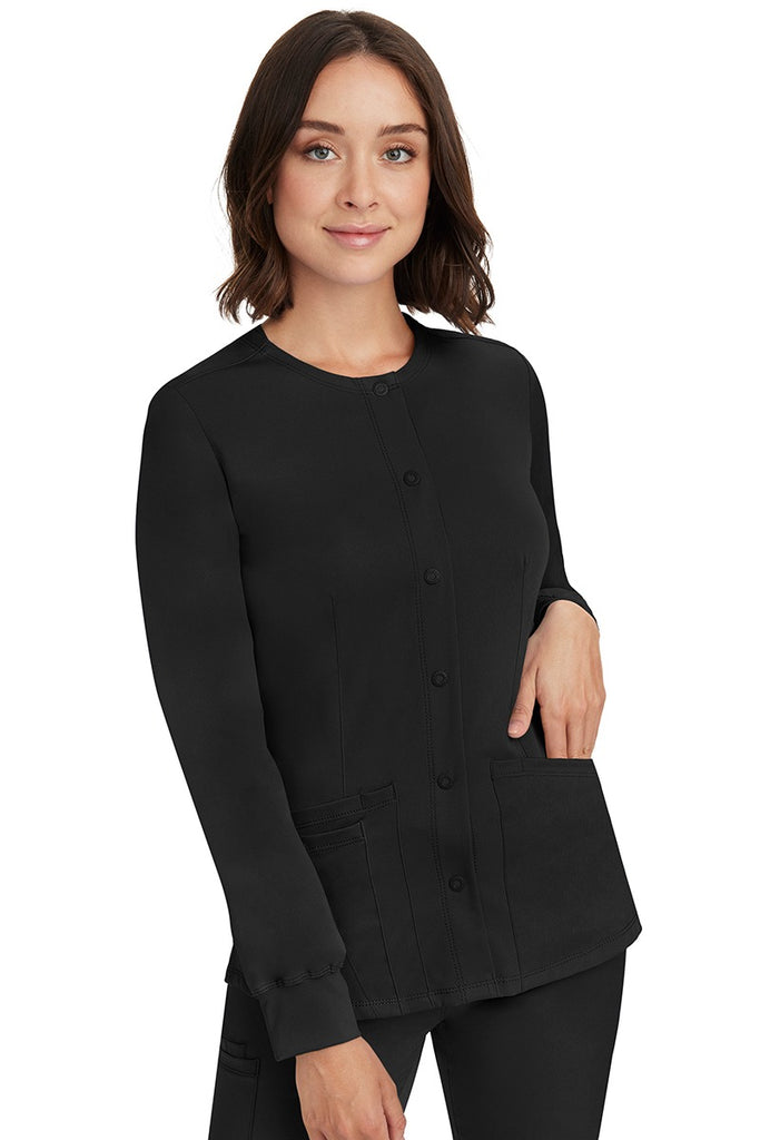 A young lady RN wearing an HH-Works Women's Megan Snap Front Scrub Jacket in Black featuring front princess seaming to ensure a flattering fit.