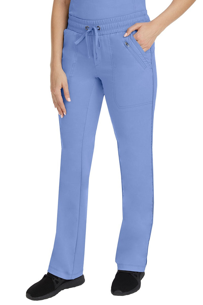A young Home Care Registered Nurse wearing a pair of Purple Label Women's Tanya Drawstring Cargo Scrub Pant in Ceil featuring 2 front slash pockets.