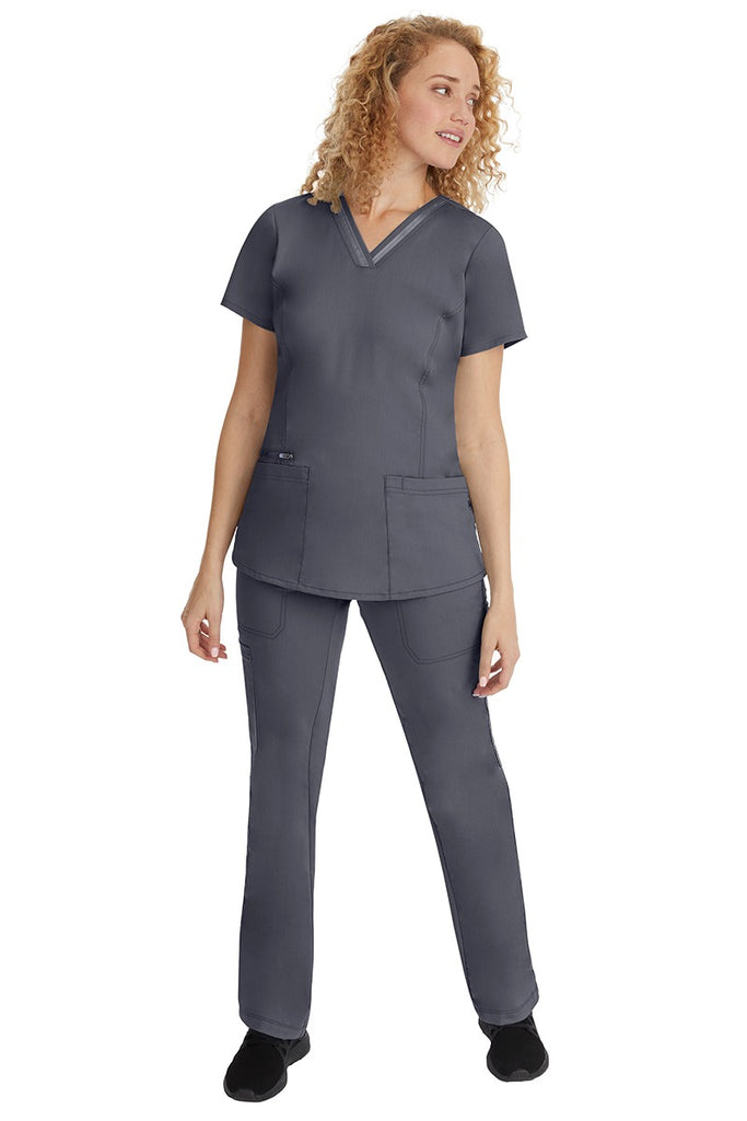 A young woman wearing a pair of Purple Label Women's Tanya Drawstring Cargo Scrub Pant from Healing Hands in Pewter size small.