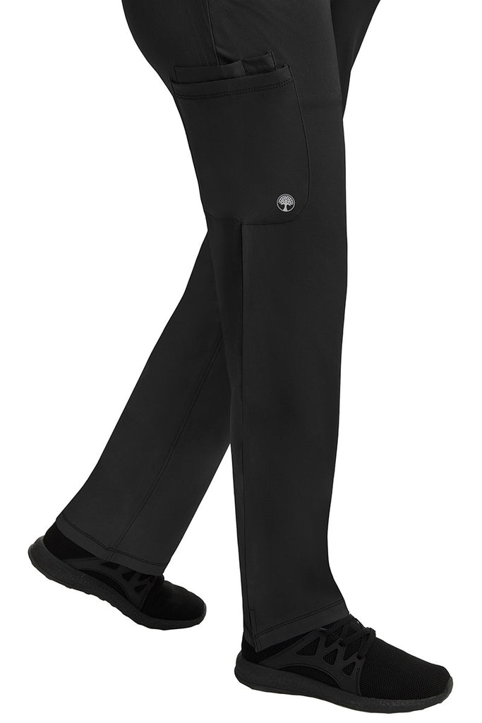 A young female healthcare professional wearing an HH-Works Women's Rose Maternity Cargo Scrub Pant in Black featuring a super comfortable stretch fabric made of 91% polyester & 9% spandex.