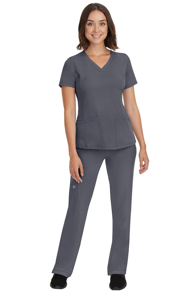 A young female nurse wearing a Women's Rebecca Multi-Pocket Drawstring Pant from HH Works in Pewter featuring a quick-dry, moisture wicking fabric that is fade resistant.