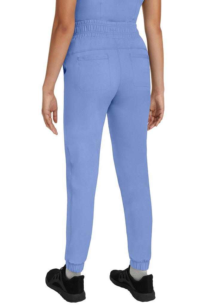 A young Home Care Registered Nurse wearing a Women's Renee Jogger Scrub Pant from HH Works in Ceil featuring 2 back patch pockets for additional storage room.