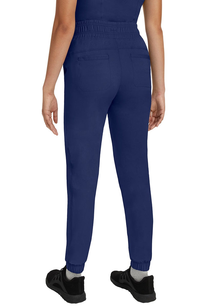 A young Home Care Registered Nurse wearing a Women's Renee Jogger Scrub Pant from HH Works in Navy featuring 2 back patch pockets for additional storage room.