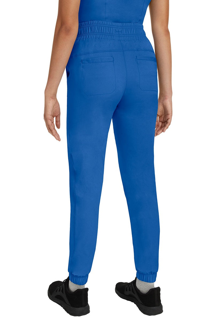 A young Home Care Registered Nurse wearing a Women's Renee Jogger Scrub Pant from HH Works in Royal featuring 2 back patch pockets for additional storage room.