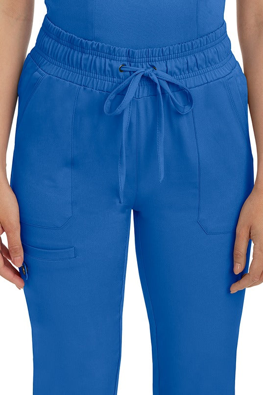 A female nurse wearing a Women's Renee Jogger Scrub Pant from HH Works in Royal  featuring a drawstring tie front.