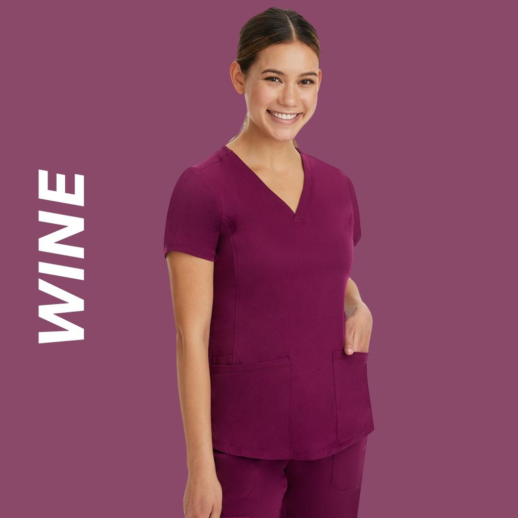 A young female Surgical Assistant wearing Wine scrubs on a burgundy background with text ott the left stating "Wine".