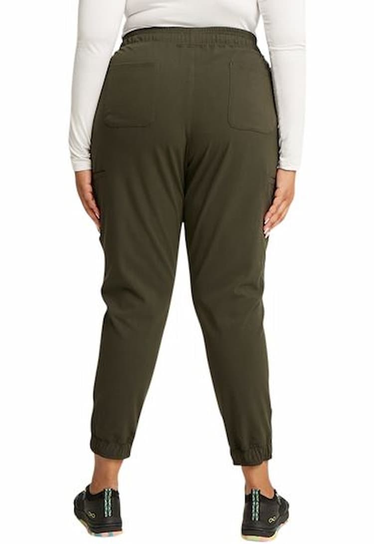 A young female Registered Nurse wearing a Vince Camuto Women's Mid Rise Jogger in Heathered Olive size 3XL featuring 2 back patch pockets.