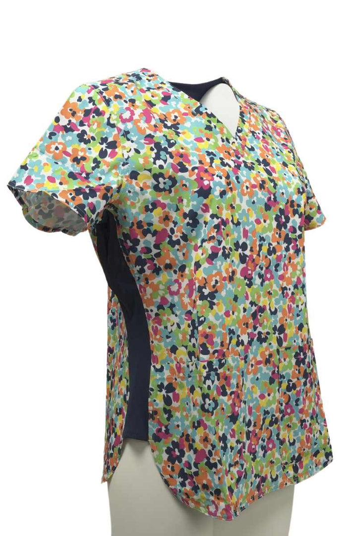 The right side of the Meraki Sport Women's Print Scrub Top in Bright Blossoms featuring short sleeves.