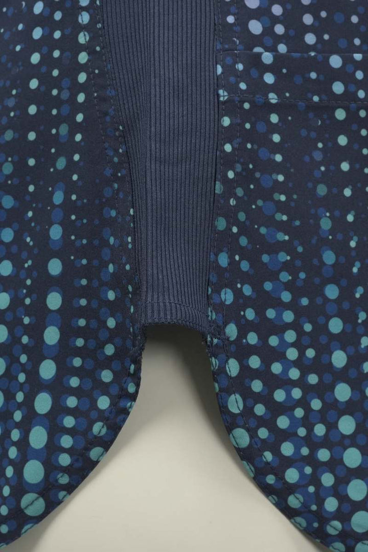 A close look at the rib-knit side panels on the Meraki Sport Women's Print Scrub Top in Dazzle n Dots.