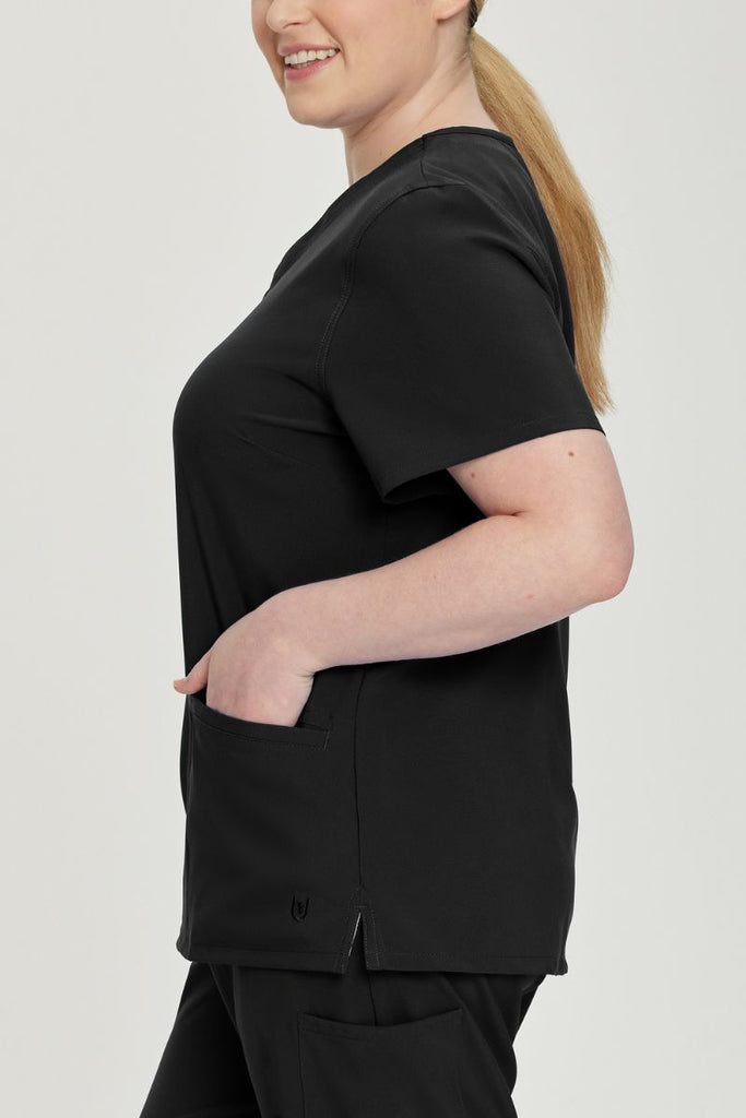 The side of the Urbane Performance Women's Motivate V-neck Scrub Top in Black size 3XL featuring two front angled welt pockets.