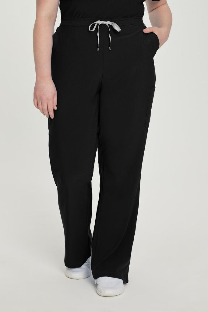 A young female Anesthesiologist wearing a pair of the Urbane Performance Women's Endurance Scrub Pants in Black size 2XL featuring six strategically placed pockets keep everything you need close at hand.