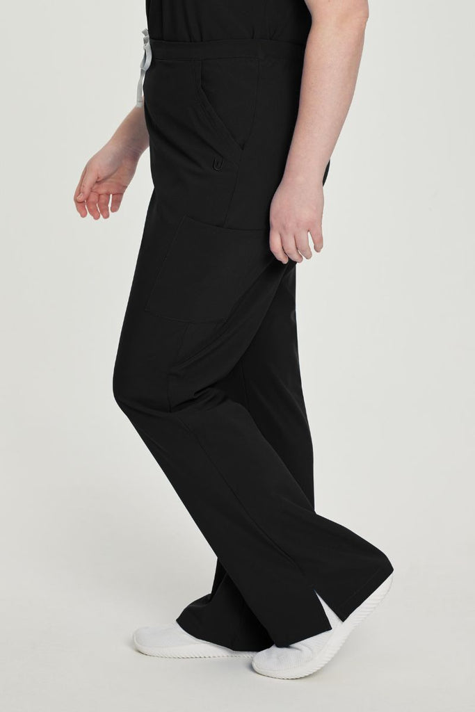 A young female EMT wearing a pair of the Urbane Performance Women's Endurance Cargo Scrub Pants in Black size 3XL featuring a modern, tailored silhouette flatters your figure without sacrificing comfort.