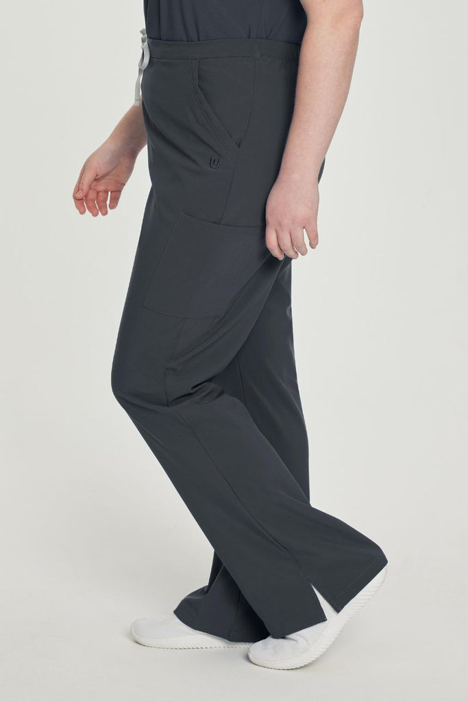 A young female EKG Technician wearing a pair of the Urbane Performance Endurance Cargo Scrub Pants in Graphite size 3XL featuring a breathable fabric wicks away moisture, keeping you cool and comfortable even during demanding tasks.
