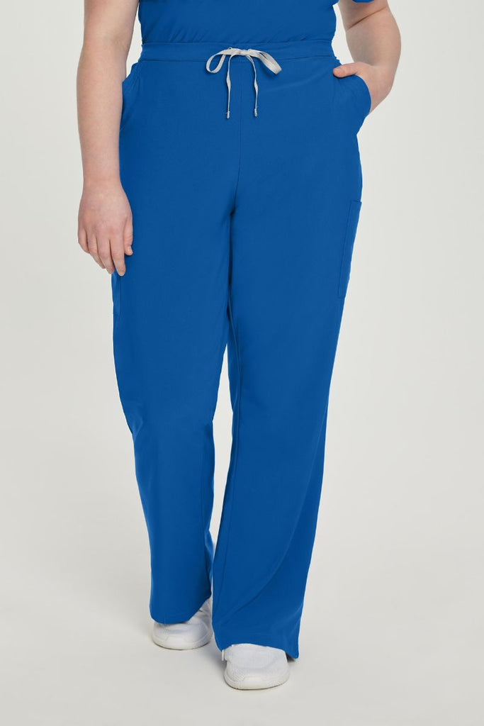 A young female Physical Therapist showcasing the front of the Urbane Performance Endurance Cargo Pants in New Royal size 4XL featuring a mid-rise construction with a drawstring closure.