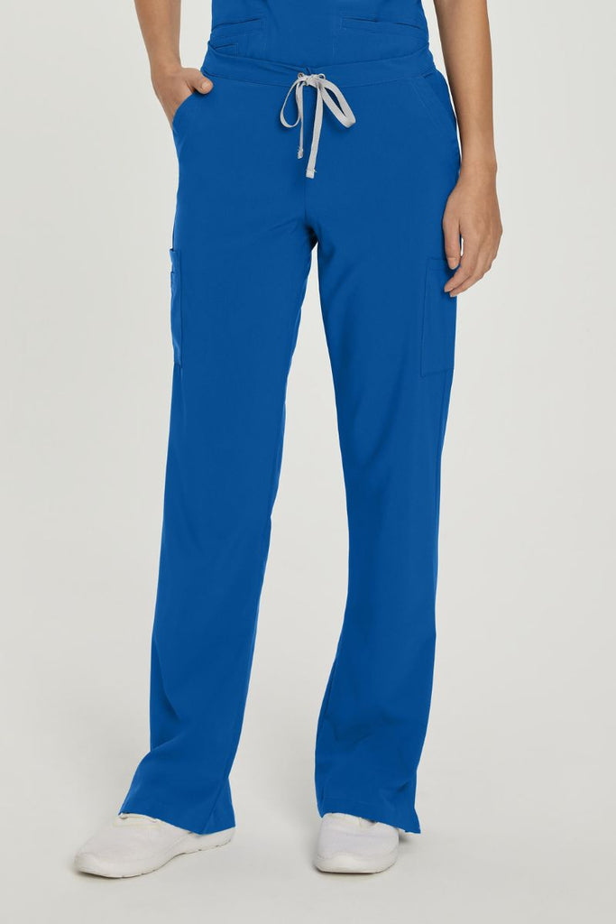 A young female Registered Nurse wearing a pair of Urbane Performance Endurance Cargo Pants in Royal Blue size Small featuring a modern, tailored silhouette.