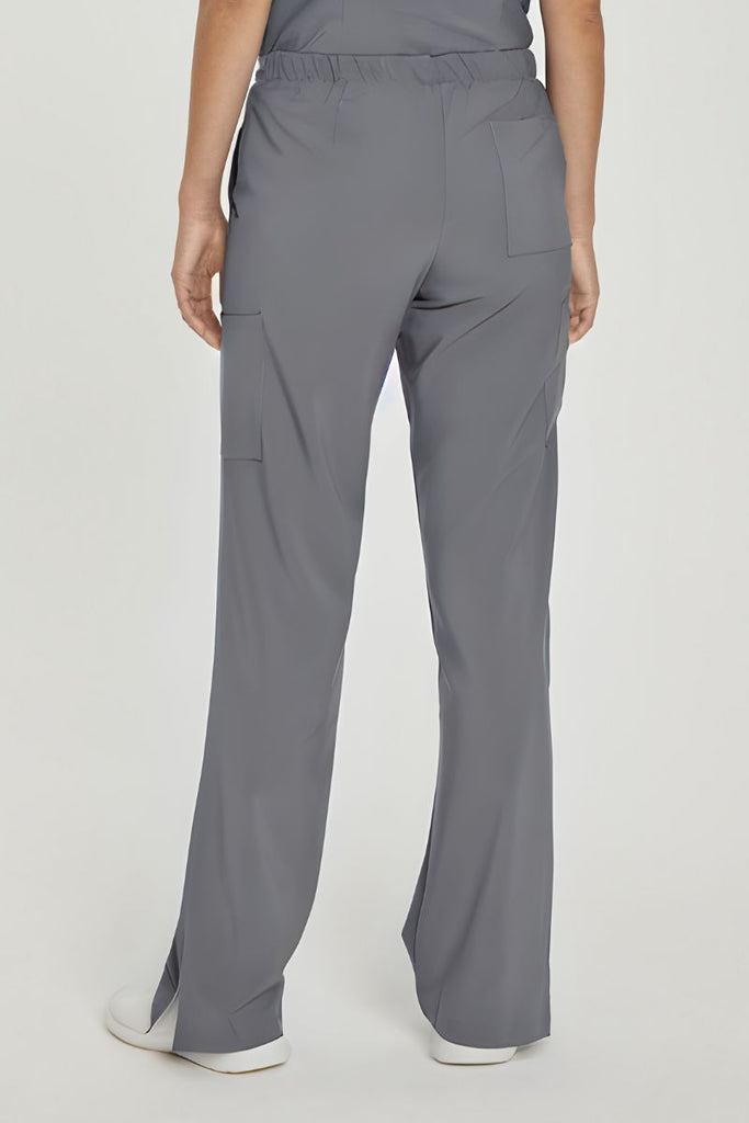 A young female LPN wearing a pair of the Urbane Performance Women's Endurance Cargo Scrub Pants in Steel size Large featuring a modern, tailored silhouette flatters your figure without sacrificing comfort.