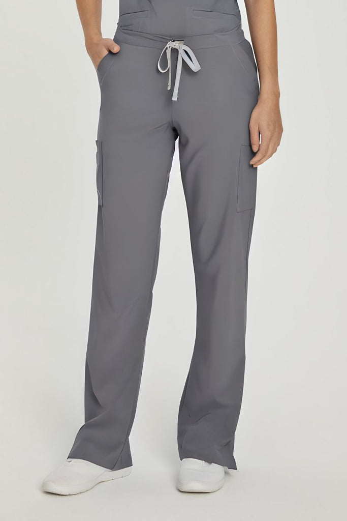 A young female Hospital Receptionist wearing a pair of Urbane Performance Endurance Cargo Pants in Steel size Medium featuring a mid-rise design sits comfortably at your natural waist, while the drawstring closure allows for a personalized fit.