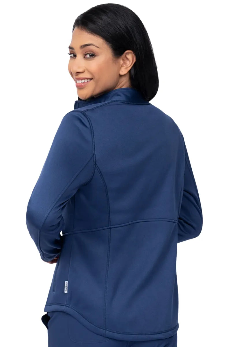 An image of the back of a nursing assistant wearing an Ava Therese Women's Bonded Fleece Jacket in Navy size Medium featuring stylish seaming throughout.