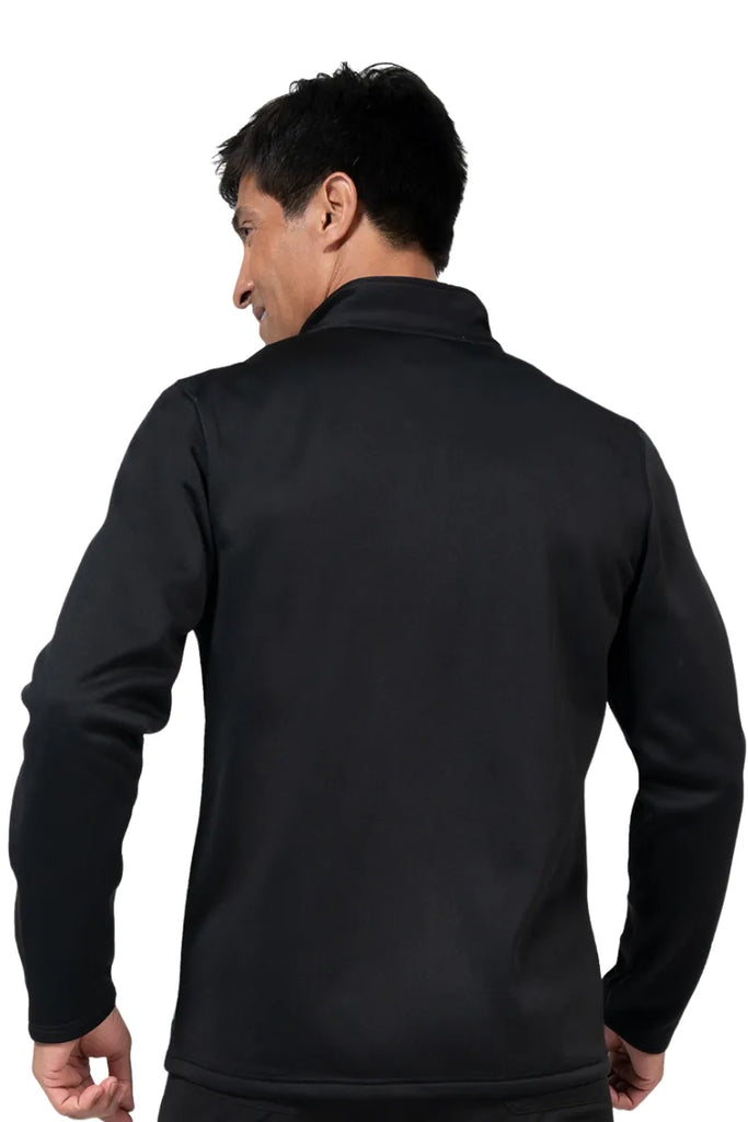 A young male medical assistant wearing a Brandon Men's Bonded Fleece Jacket in Black size 3XL featuring a two front on seam pockets for all your on the job storage needs.