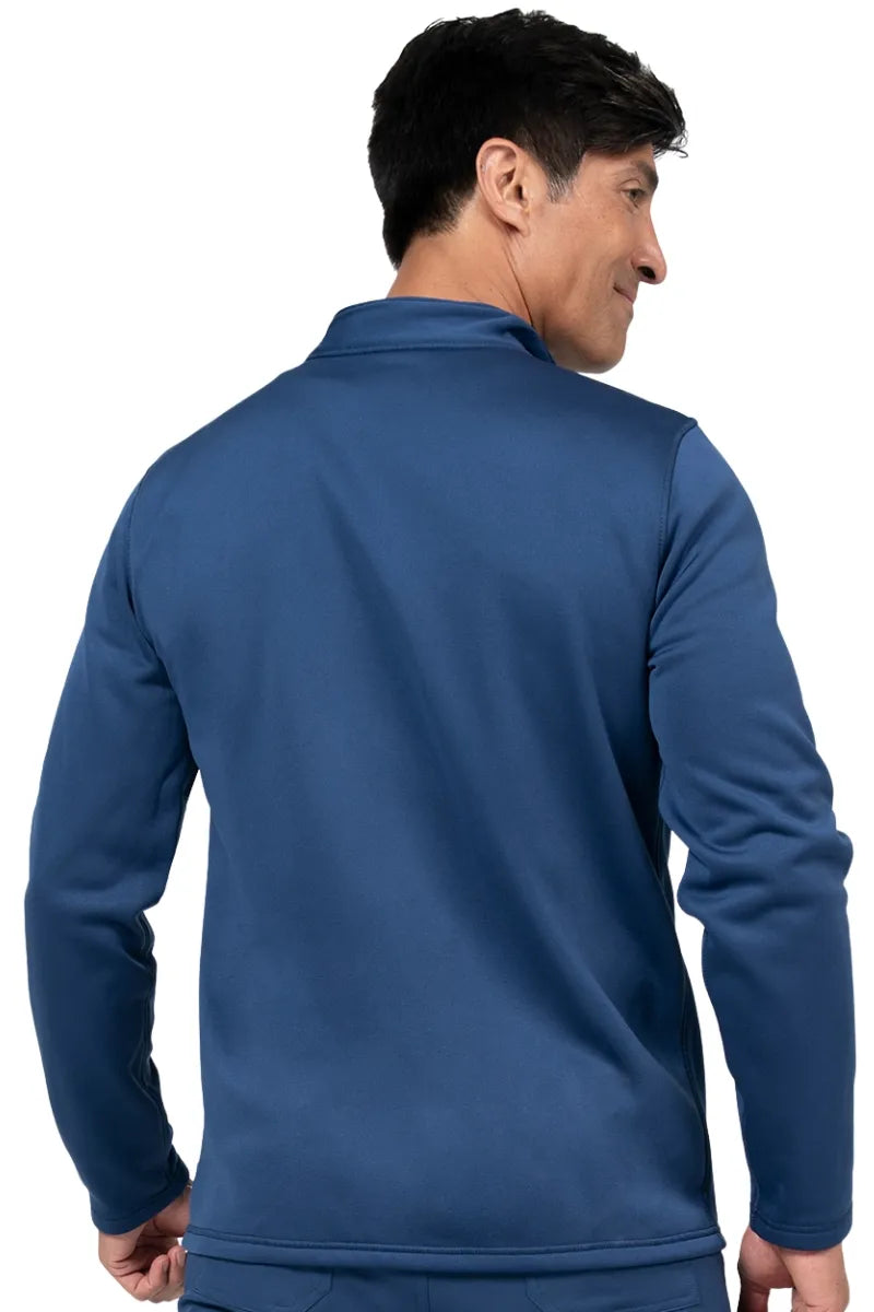 An image of a middle aged male LPN wearing a Brandon Men's Bonded Fleece Jacket in Navy size XL featuring a soft, light fleece has an anti-static finish.