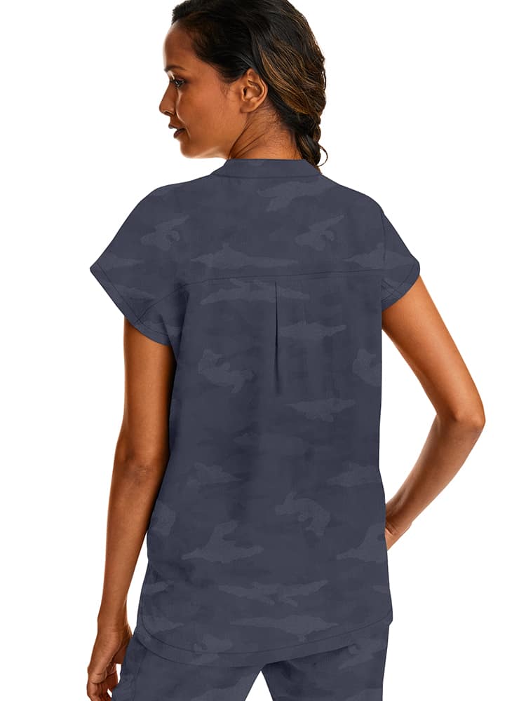 A young female Occupational Therapy Aide wearing a Purple Label Women's Journey Camo Top in Pewter size Large featuring a center back length of 26.5".