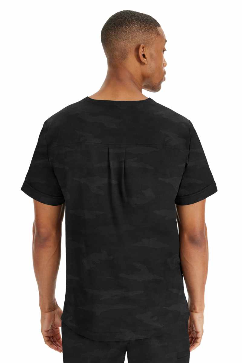 An image of a young male Home Health Aide wearing a Purple Label by Healing Hands Men's Jack Camo Scrub Top in "Black"  size Large featuring a center back yoke with box pleat detail.