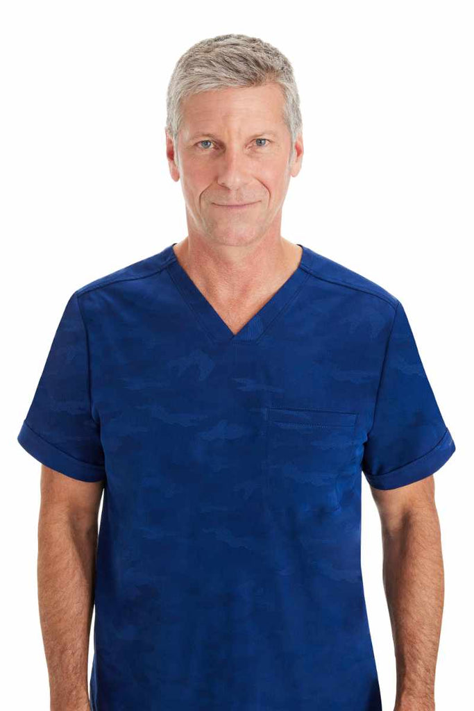 An up close image of the Purple Label by Healing Hands Men's Jack Camo Scrub Top in "Navy" size Small featuring a subtle camo design throughout.
