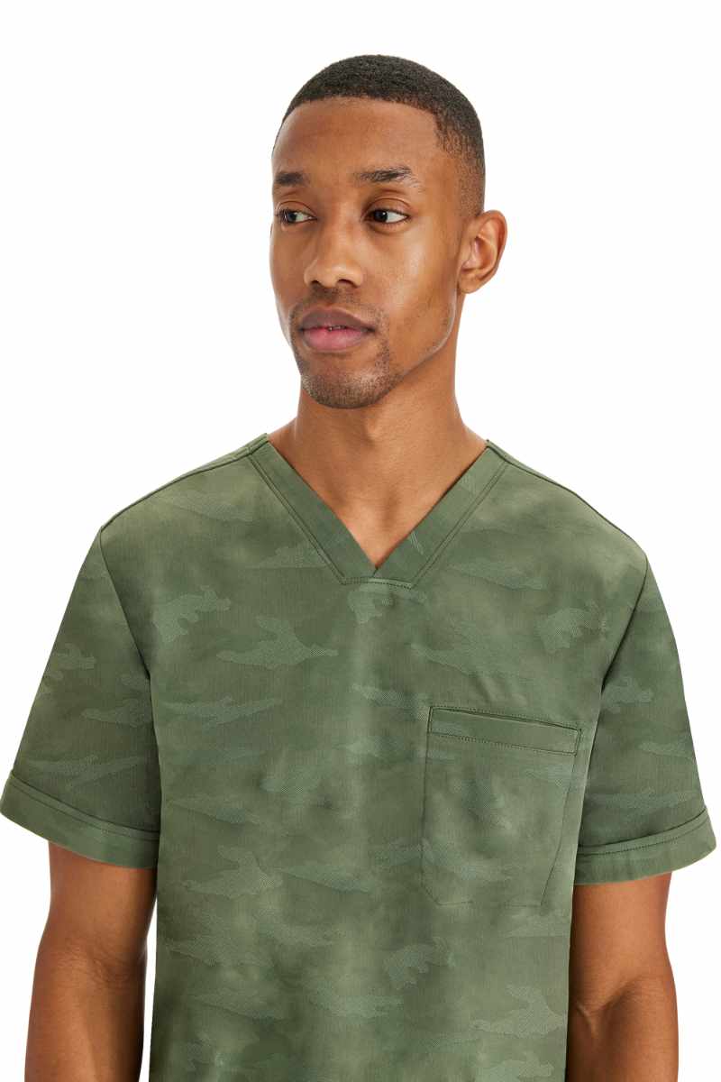An up close image of the Purple Label by Healing Hands Men's Jack Camo Scrub Top in "Olive" size Small featuring a subtle camo design throughout.