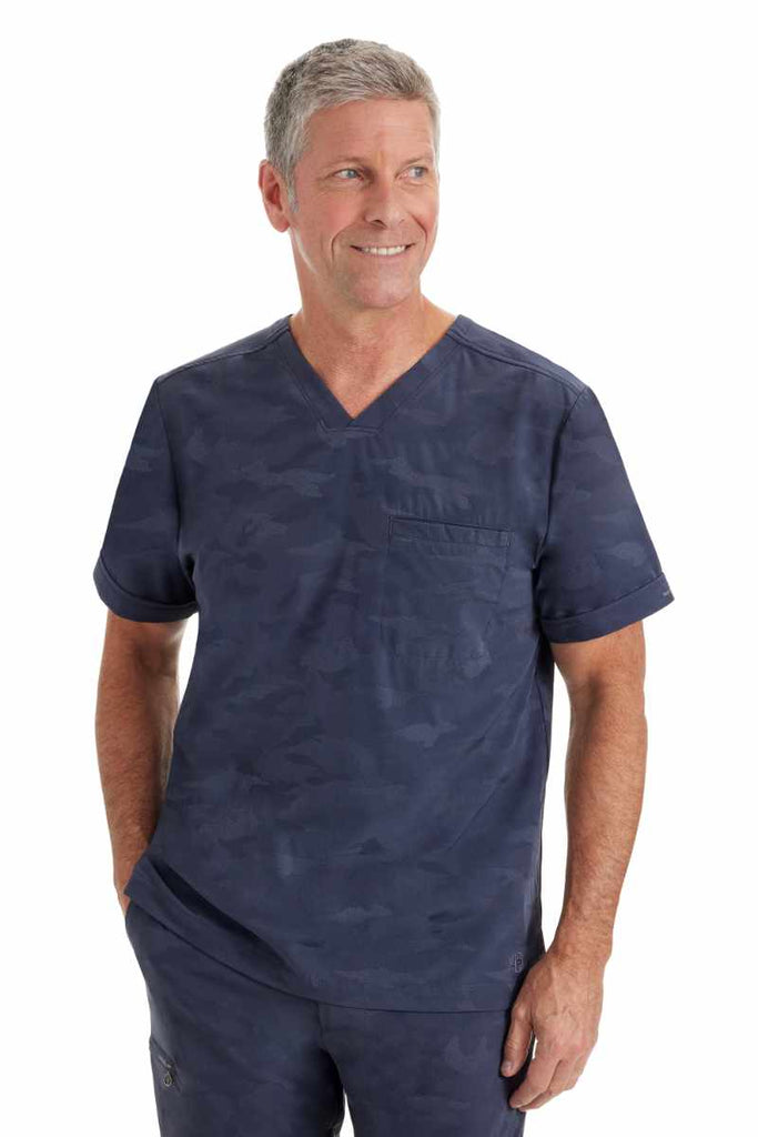 A male Dietician wearing a Purple Label by Healing Hands Men's Jack Camo Scrub Top in "Pewter" size medium featuring 1 chest pocket on the wearer's left side.