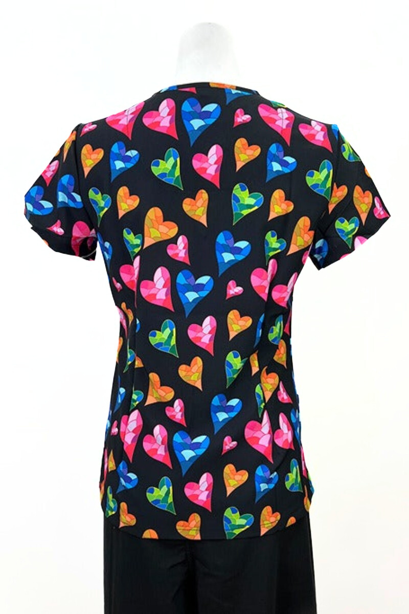 An image of the Revel Women's V-neck Print Scrub Top in "Mosaic Love" size Small featuring side slits for additional range of motion throughout the day.