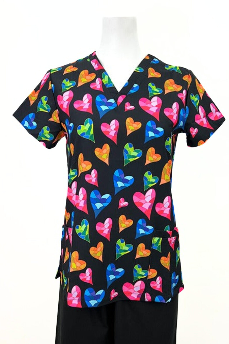 A frontward facing image of the Revel Women's V-Neck Print Scrub Top in "Mosaic Love" size Medium featuring a total of 3 pockets & a contemporary fit.