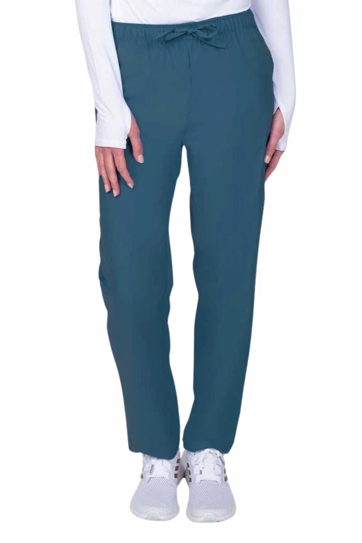 Young woman wearing a Luv Scrubs by MedWorks Women's Elastic Waist Cargo Pant in Caribbean featuring one cargo pocket on the wearer's left side.