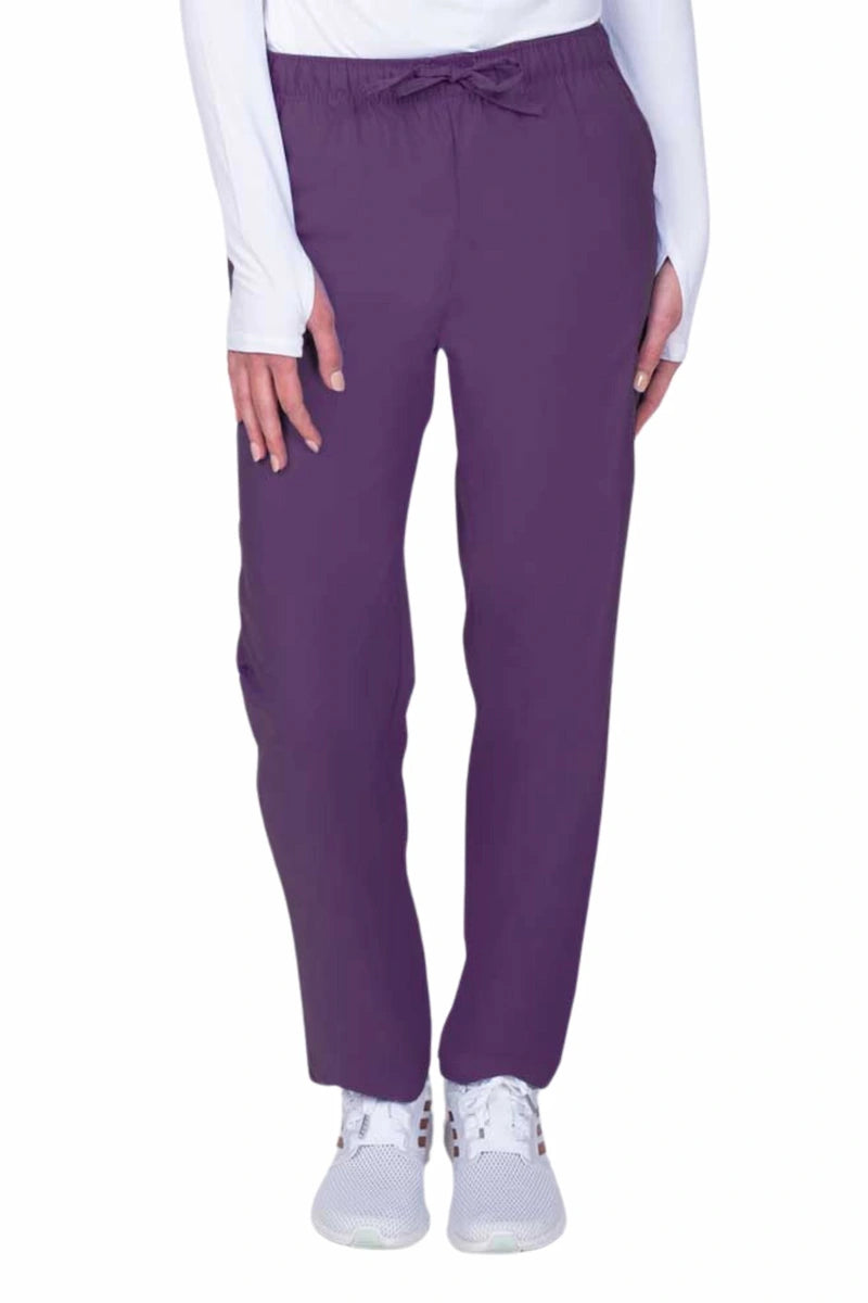 Young woman wearing a Luv Scrubs by MedWorks Women's Elastic Waist Cargo Pant in eggplant featuring one cargo pocket on the wearer's left side.