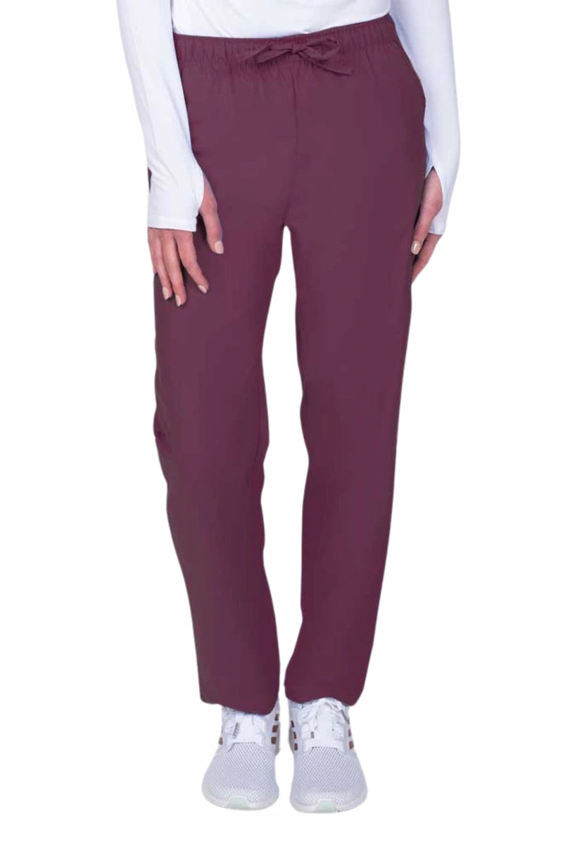 Young woman wearing a Luv Scrubs by MedWorks Women's Elastic Waist Cargo Pant in wine featuring one cargo pocket on the wearer's left side.